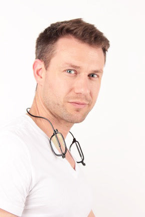 Man with black Magnet Eyes glasses around neck